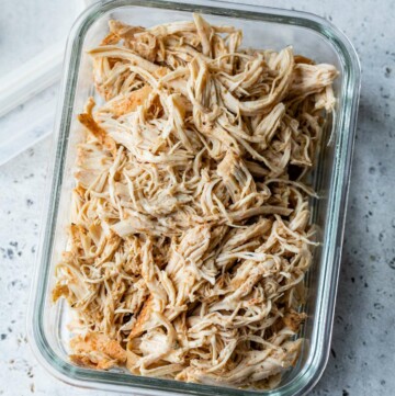 Shredded chicken in a meal prep storage container.