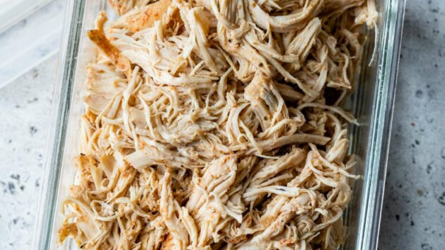 Shredded chicken in a meal prep storage container.