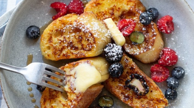 Sourdough French toast topped with berries and butter.