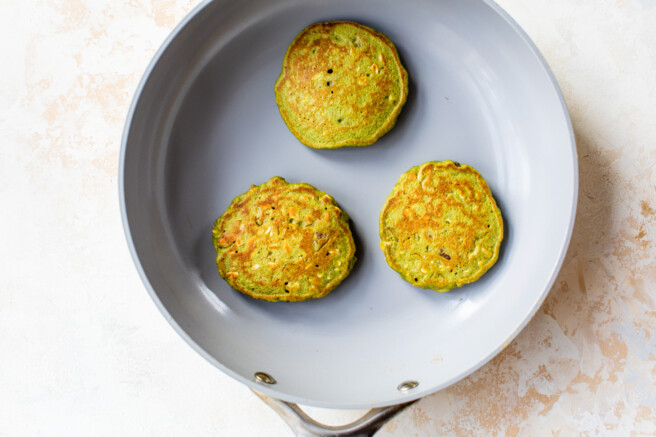 spinach pancakes cooked in a saute pan