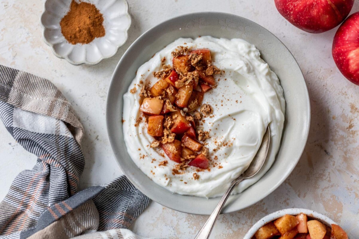 Bowl with Greek Yogurt topped with stovetop cinnamon apples.