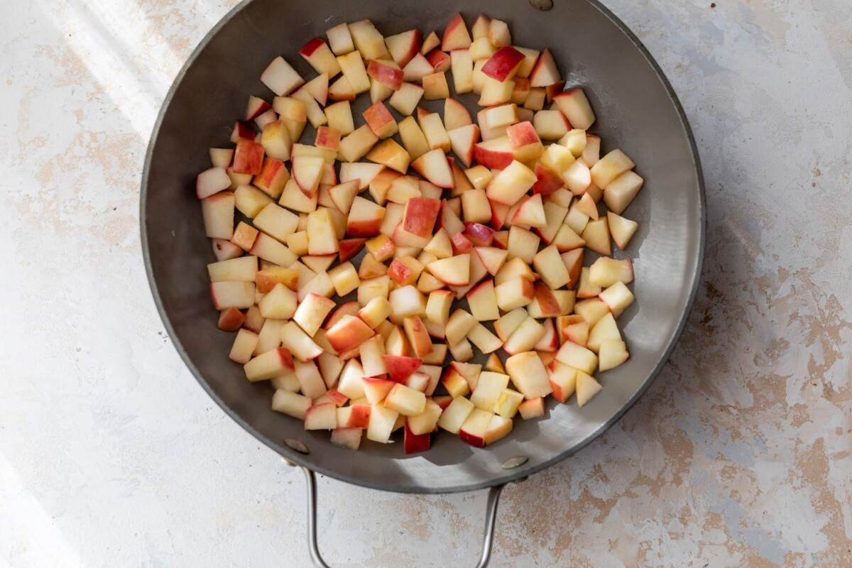 Apples cooking in a skillet.