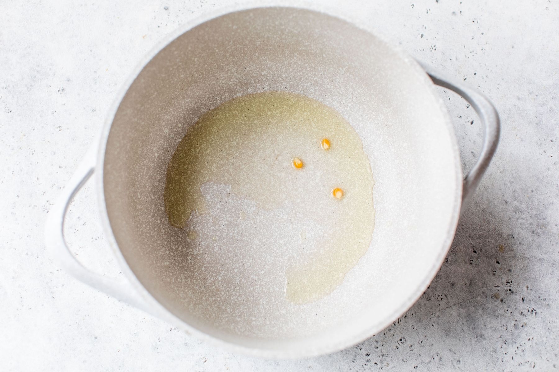 Adding a couple of kernels into oil.