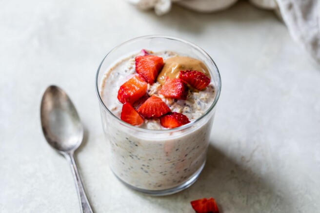 Strawberry overnight oats topped with chopped strawberries and peanut butter.