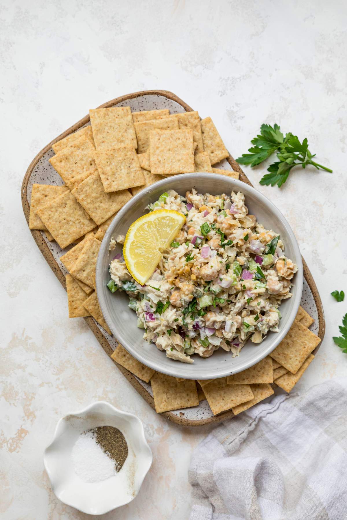 Tuna Chickpea Salad served with crackers and lemon slices.