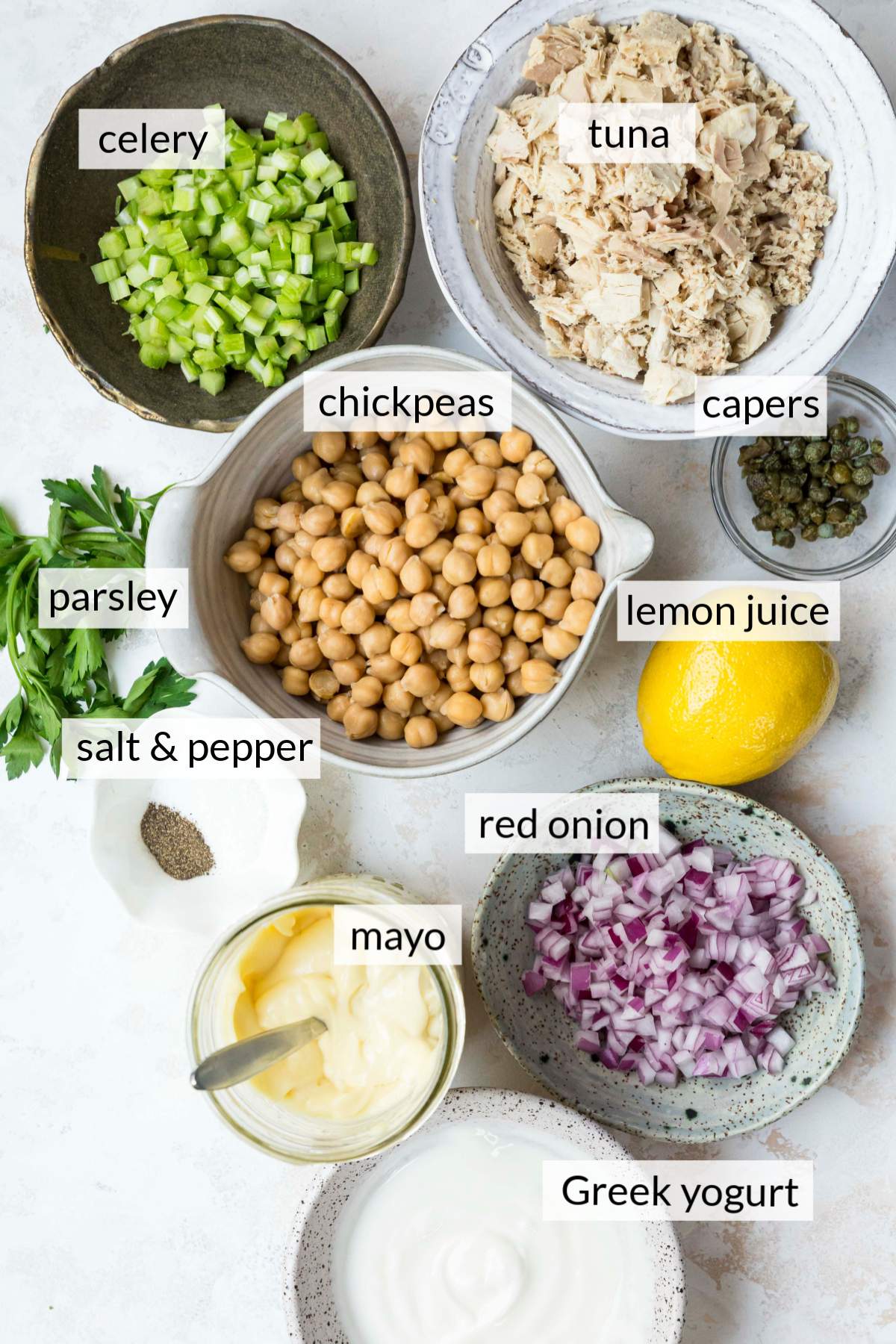 Small bowls with tuna, chickpeas, celery, red onion, Greek Yogurt and mayo.