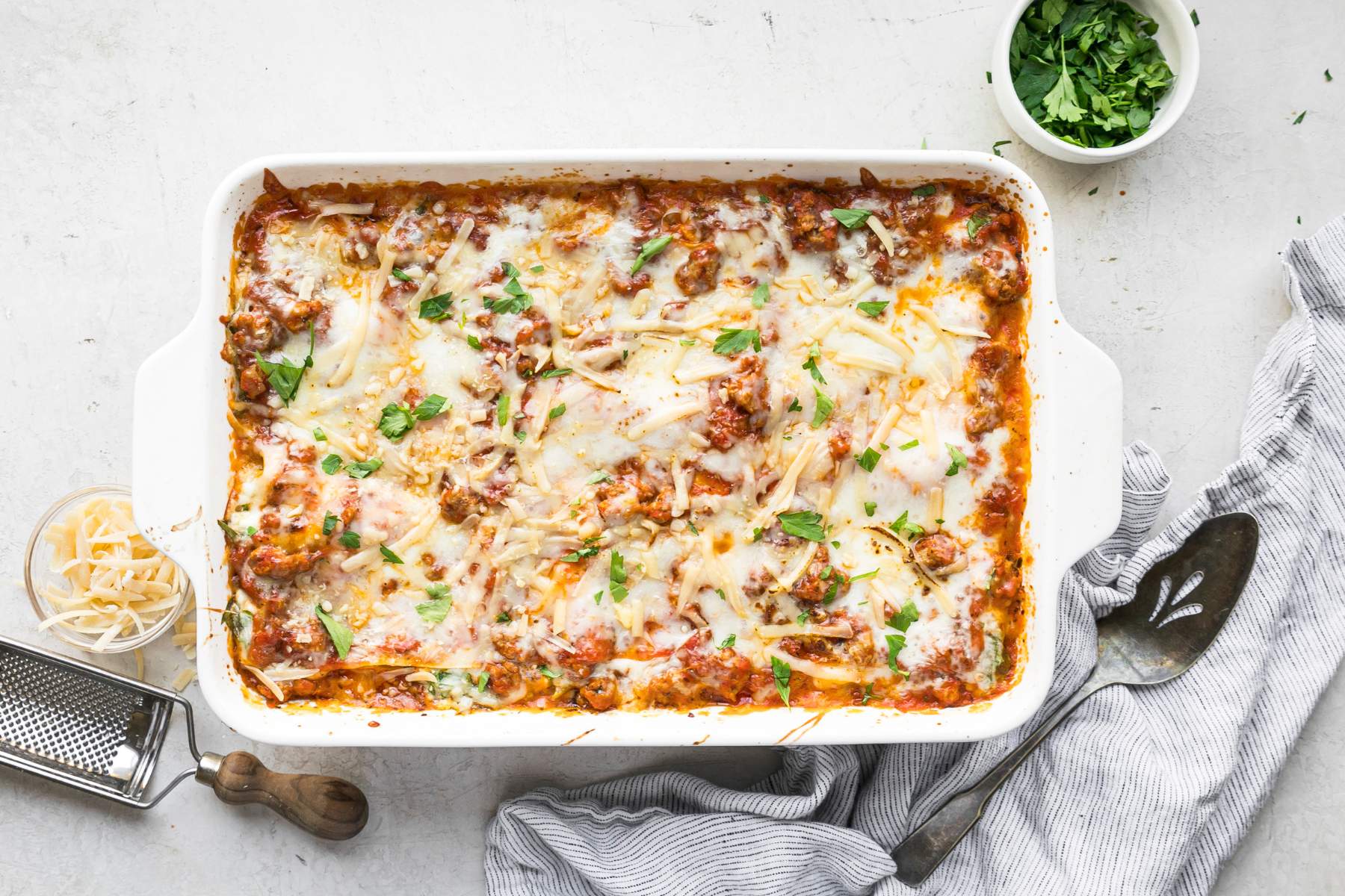 Turkey spinach lasagna garnished with fresh parsley.
