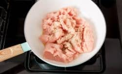 raw ground turkey added to a skillet