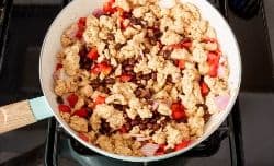 ground turkey mixed with black beans, onion and peppers in a skillet