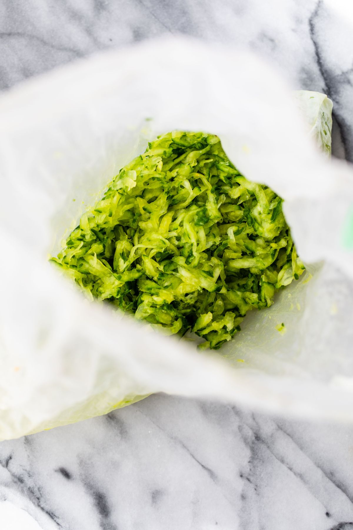 Straining water from grated cucumber.